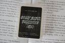 Wax melt packaging for the scent 'in my dark romance era' displayed on an open book background