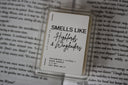 Wax melt packaging for the scent "smells like highlords and wingleaders" displayed on an open book