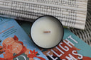All Booked for Christmas mini candle with wooden wick on colorful holiday book covers