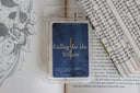 Wax melt packaging labeled 'Falling for the Villain' on a book with text and a skull illustration.