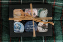 Set of six mini book-themed candles with decorative labels tied together with twine