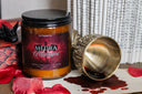Candle with 'MEDRA Pendragon' label next to a cauldron dripping with 'blood'