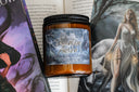 Licensed book candle Tessalyn Ausra in front of fantasy book with ethereal woman in flowing gown
