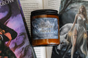 Licensed Tessalyn Austra candle in front of fantasy book with ethereal woman in flowing gown
