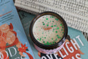 All Booked for Christmas holiday candle with festive sprinkle design and wooden wick