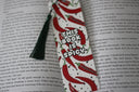 handmade bookmark in white covered in illustrated red chili peppers and text that reads 'this book is spicy'