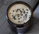 Top view of candle displaying wick, wax, and candle confetti